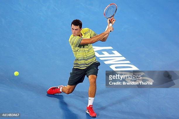 Bernard Tomic of Australia plays a backhand in his quarter final match against Alexandr Dolgopolov of the Ukraine during day five of the 2014 Sydney...