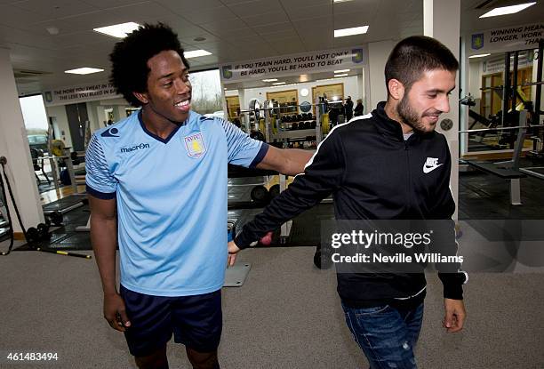 New signing Carles Gil of Aston Villa meets his new team mate Carlos Sanchez at the club's training ground at Bodymoor Heath on January 13, 2015 in...