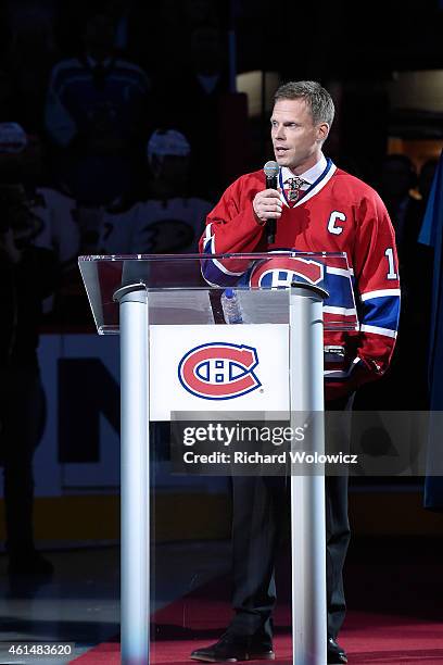 Former Montreal Canadien player Saku Koivu speaks to fans during a ceremony honouring the former team captain prior to the NHL game between the...