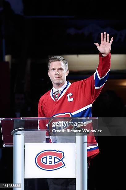 Former Montreal Canadien player Saku Koivu speaks to fans during a ceremony honouring the former team captain prior to the NHL game between the...