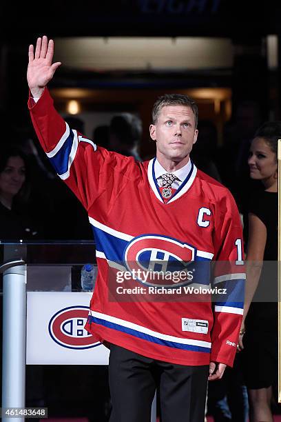 Former Montreal Canadien player Saku Koivu speaks to fans during a ceremony honouring the former team captain prior to the NHL game between the...