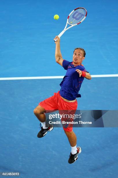 Alexandr Dolgopolov of the Ukraine plays a smash shot in his quarter final match against Bernard Tomic of Australia during day five of the 2014...