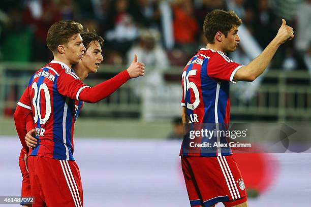 Mitchell Weiser of Muenchen celebrates his team's second goal with team mate Thomas Mueller during a friendly match between FC Bayern Muenchen and...