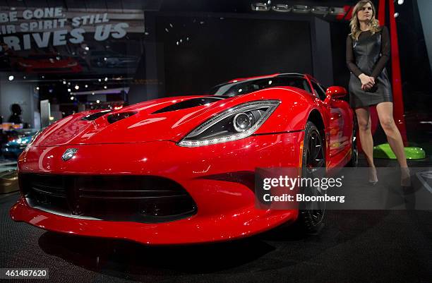 Product specialist stands next to a Chrysler Group LLC 2015 Dodge GT Viper during the 2015 North American International Auto Show in Detroit,...