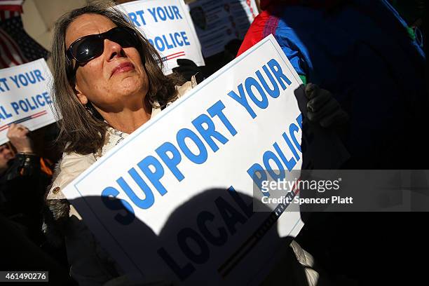 Supporters of the New York Police Department attend a "Support Your Local Police" news conference and rally at Queens Borough Hall on January 13,...