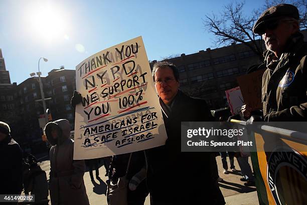 Supporters of the New York Police Department attend a "Support Your Local Police" news conference and rally at Queens Borough Hall on January 13,...