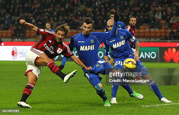 Alessio Cerci of AC Milan is challenged by Alessandro Longhi of US Sassuolo Calcio during the TIM Cup match between AC Milan and US Sassuolo Calcio...