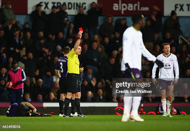 Aidan McGeady of Everton is shown a red card and is sent off by referee Neil Swarbrick after a challenge on Mark Noble of West Ham United during the...