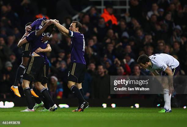 Despair for Leighton Baines of Everton as Enner Valencia of West Ham United celebrates with team mates as he scores their first goal during the FA...