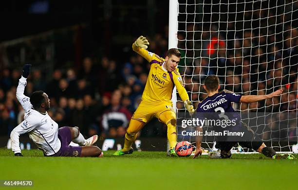 Romelu Lukaku of Everton slides the ball past Adrian and Aaron Cresswell of West Ham United to score their second goal during the FA Cup Third Round...