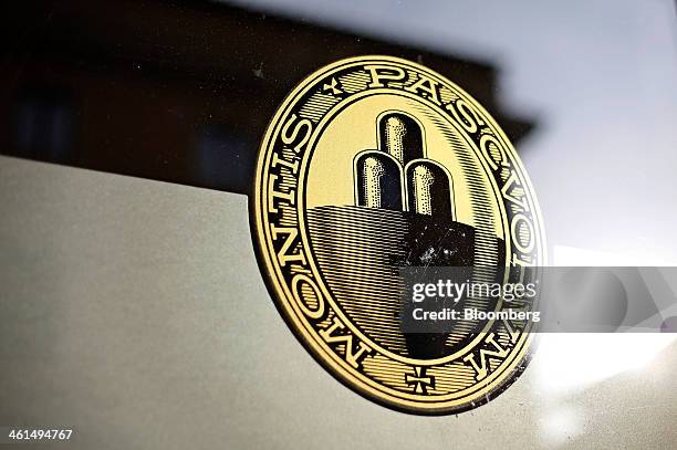 Logo sits on the window of a Banca Monte dei Paschi di Siena SpA bank branch in Siena, Italy, on Wednesday, Jan. 8, 2014. Monte Paschi, the bailed...