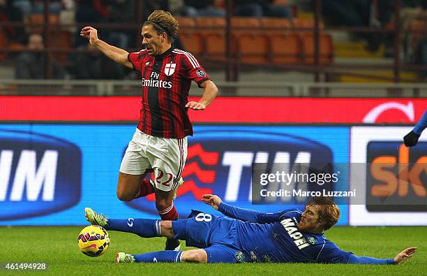 Alessio Cerci of AC Milan is challenged by Davide Biondini of US Sassuolo Calcio during the TIM Cup match between AC Milan and US Sassuolo Calcio at...