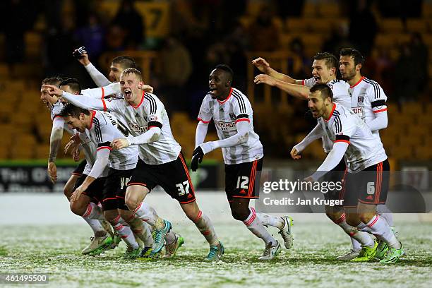 Fulham players celebrate victory after a penalty shootout in the FA Cup third round replay match between Wolverhampton Wanderers and Fulham at...