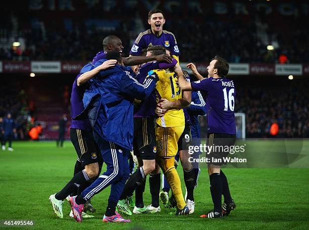 Adrian of West Ham United celebrates with team mates as he scores the winning penalty in the shoot out during the FA Cup Third Round Replay match...