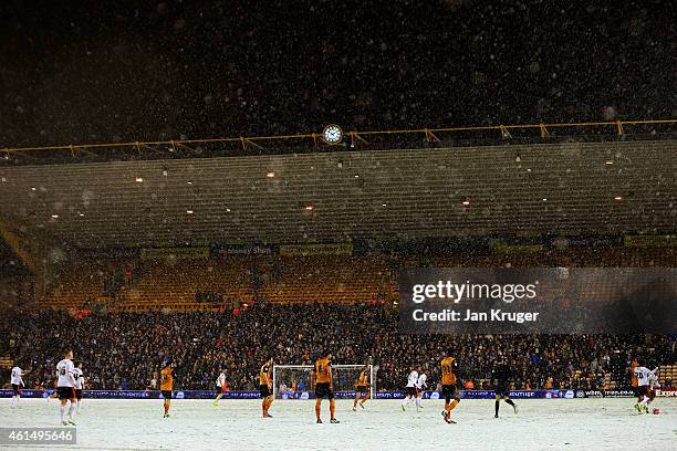 Snow falls during the FA Cup third round replay match between Wolverhampton Wanderers and Fulham at Molineux on January 13, 2015 in Wolverhampton,...