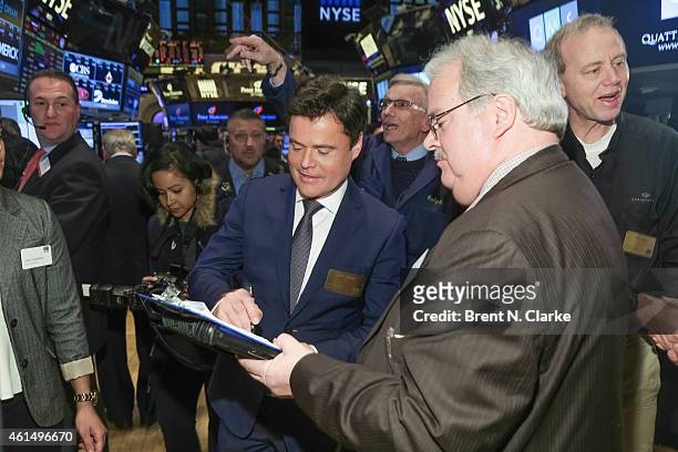 Entertainer Donny Osmond greets a trader prior to ringing the NYSE closing bell to celebrate the release of his 60th album at the New York Stock...