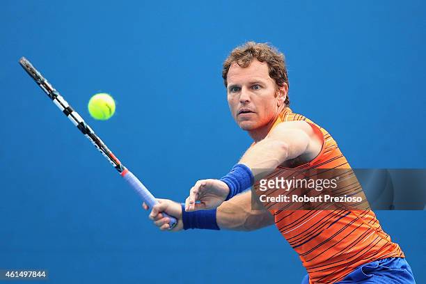 Michael Russell of USA plays a forehand in his qualifying match against Denys Molchanov of Ukraine for 2015 Australian Open at Melbourne Park on...
