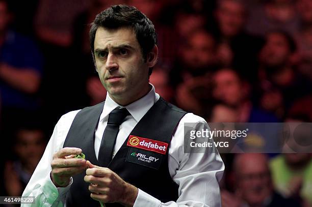 Ronnie O'Sullivan of London chalks his cue against Ricky Walden of UK during day three of the 2015 Dafabet Masters at Alexandra Palace on January 13,...