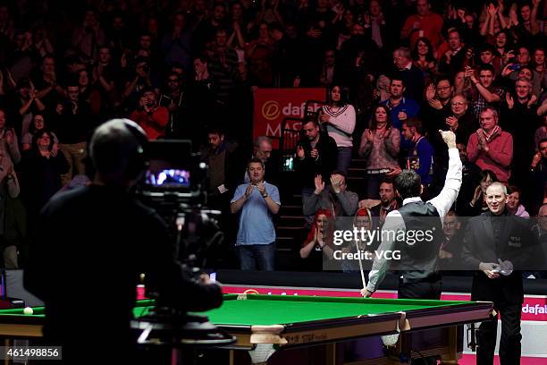 Ronnie O'Sullivan of UK stricks a triumph pose against Ricky Walden of UK during day three of the 2015 Dafabet Masters at Alexandra Palace on January...