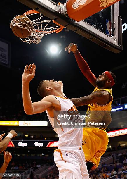 LeBron James of the Cleveland Cavaliers slam dunks the ball over Alex Len of the Phoenix Suns during the first half of the NBA game at US Airways...