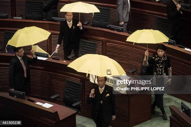 Pro-democracy lawmakers walk out in protest before the policy address of Hong Kong Chief Executive Leung Chun-ying in the legislative council in Hong...