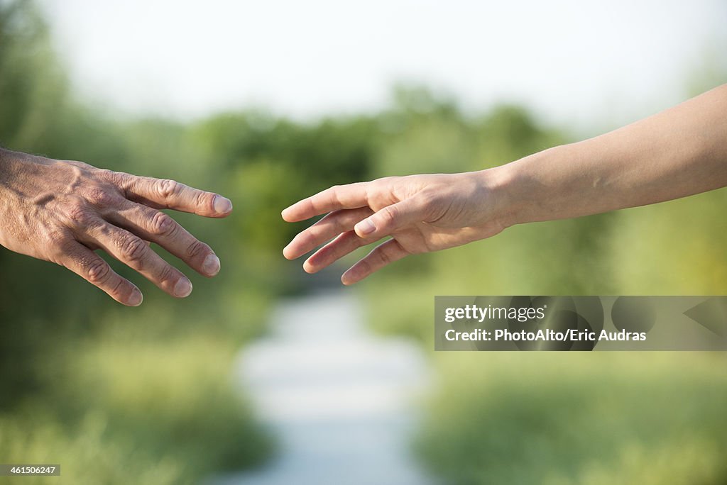 Couple reaching out to hold hands