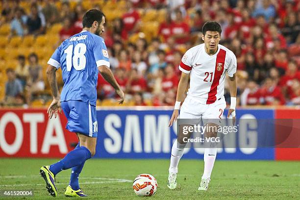 Yu Hai of China is pressured by Timur Kapadze of Uzbekistan during the 2015 Asian Cup match between China PR and Uzbekistan at Suncorp Stadium on...