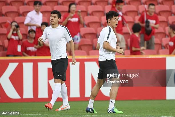 Mei Fang and Zheng Zhi of China warm up before the 2015 Asian Cup match between China PR and Uzbekistan at Suncorp Stadium on January 14, 2015 in...