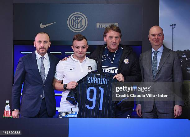 Sporting Drector Piero Ausilio, Xherdan Shaqiri, Head coach Roberto Mancini and Managing Director and COO Marco Fassone pose for a photo during a...