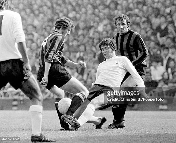 Joe Kinnear of Tottenham Hotspur tackles Mike Doyle of Manchester City watched by Mike Summerbee during the First Division match between Spurs and...