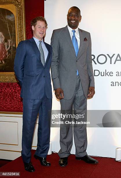 Prince Harry meets NBA global ambassador Dikembe Mutombo during a Coach Core Graduation event at St James's Palace on January 14, 2015 in London,...