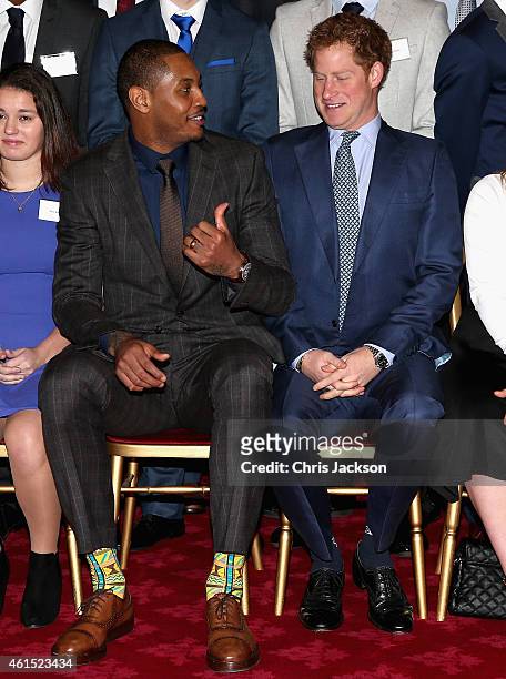Prince Harry sits with NBA All-Star Carmelo Anthony during a Coach-Core Graduation event at St James's Palace on January 14, 2015 in London, England....