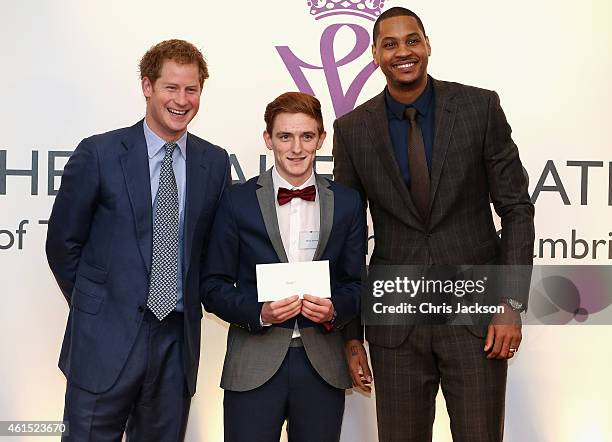 Prince Harry and NBA All-Star Carmelo Anthony present graduates with their certificates during a Coach-Core Graduation event at St James's Palace on...