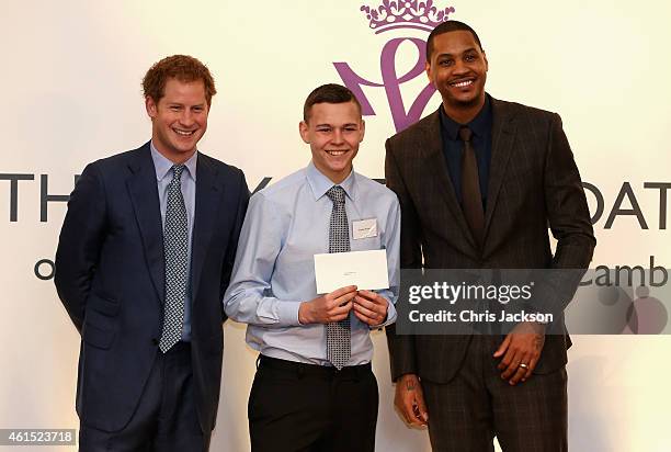 Prince Harry and NBA All-Star Carmelo Anthony present graduates with their certificates during a Coach-Core Graduation event at St James's Palace on...