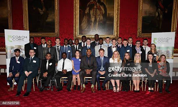 Prince Harry and NBA All-Star Carmelo Anthony pose for a photograph with Coach Core graduates during a Coach-Core Graduation event at St James's...