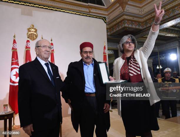 Tunisian President Beji Caid Essebsi honours Besma Khalfaoui , the widow of slain Tunisian opposition leader Chokri Belaid, and his father Salah...