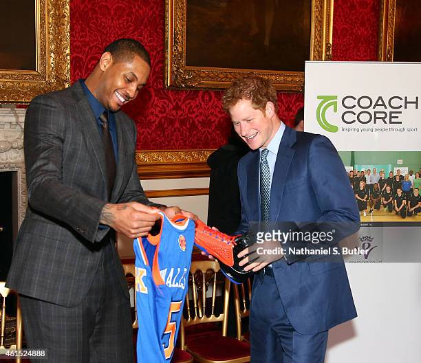 Carmelo Anthony of the New York Knicks presents a jersey and sneakers to Prince Harry at the Coach Core graduation ceremony. This event is part of...