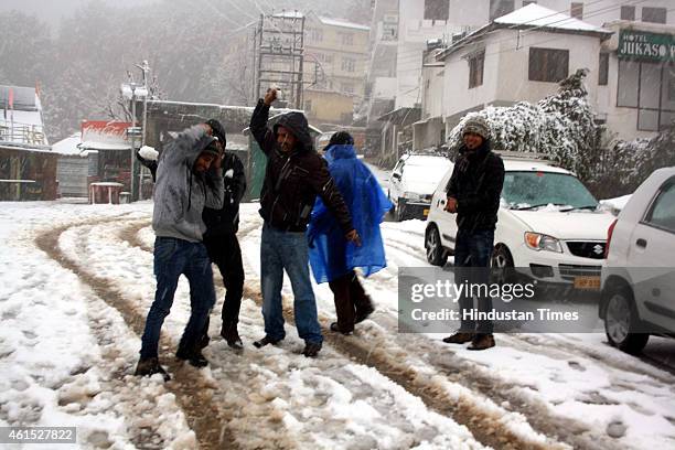 Tourists having fun with snow during snowfall at Naddi village on January 14, 2015 in Dharamsala, India. Shimla and its surrounding resorts of Kufri,...