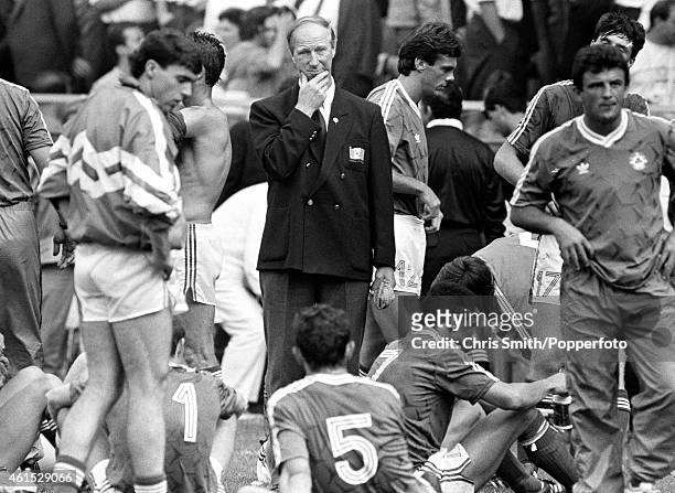 Republic of Ireland manager Jack Charlton looks thoughtful as he stands with his players prior to extra-time in the FIFA World Cup match between the...