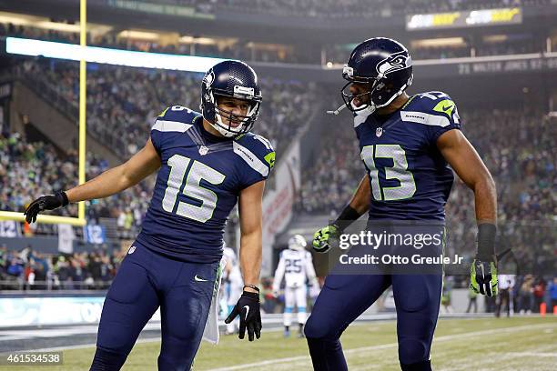 Jermaine Kearse of the Seattle Seahawks celebrates with Chris Matthews after scoring a 63 yard touchdown in the second quarter against the Carolina...