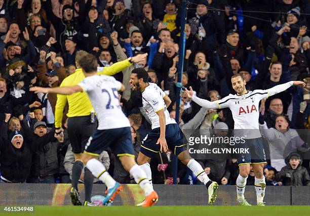 Tottenham Hotspur's French midfielder Etienne Capoue celebrates scoring the equalising goal during the English FA Cup Third Round football match...