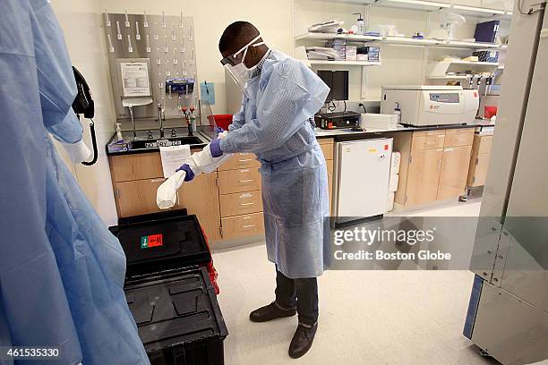 Scientist de-gowns as he leaves a lab containing the deadly Ebola virus. Scientists at the Broad Institute lost three of their partner doctors in...