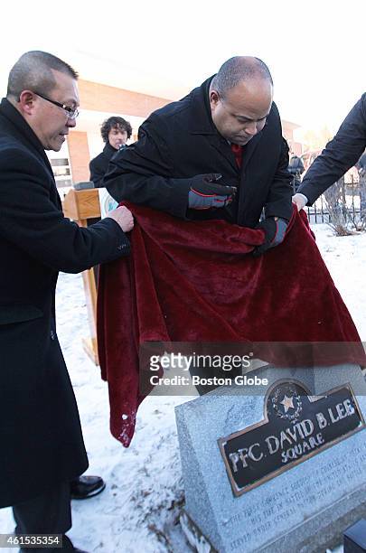 Eddie Yuen-Pui Lee, left, and Mayor Daniel Rivera unveiled a plaque honoring PFC David B. Lee during a rededication ceremony in Lawrence, Mass. On...