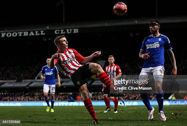 Matt Targett of Southampton clears the ball under pressure from Daryl Murphy of Ipswich during the FA Cup third round replay match between Ipswich...