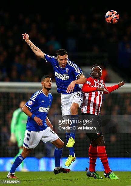 Darren Ambrose of Ipswich jumps for the ball with Victor Wanyama of Southampton during the FA Cup third round replay match between Ipswich Town and...
