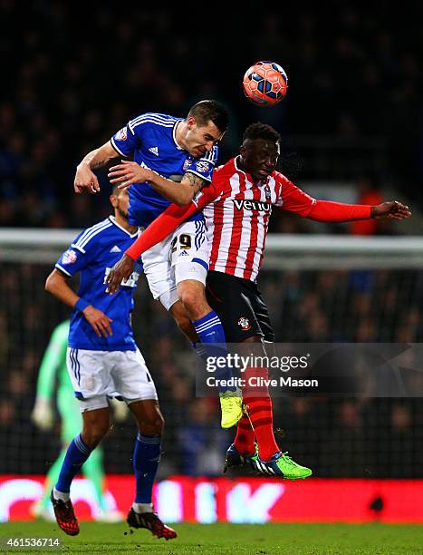 Darren Ambrose of Ipswich jumps for the ball with Victor Wanyama of Southampton during the FA Cup third round replay match between Ipswich Town and...