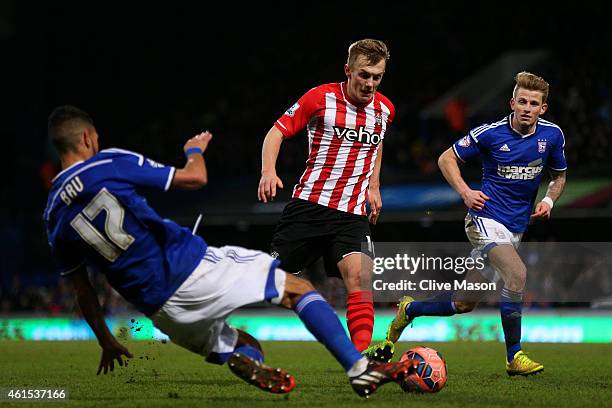 James Ward-Prowse of Southampton battles for the ball with Kevin Bru of Ipswich during the FA Cup third round replay match between Ipswich Town and...