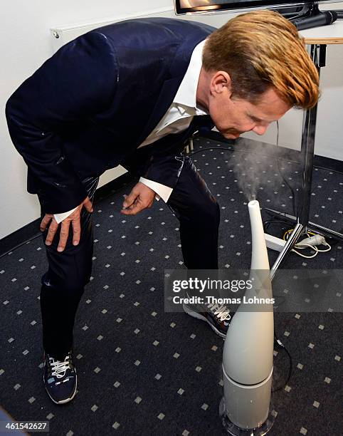 Singer and Entertainer Dieter Bohlen smells on a air humidifier before he presents at the fair 'Heimtextil 2014' his wallpaper collection 'Studio...