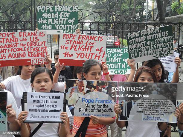 Activists display placards and postcards of Pope Francis in front of University of Santo Tomas, where the Pope is expected to meet with youth...