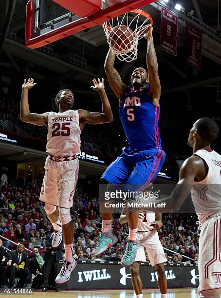 Markus Kennedy of the SMU Mustangs dunks the ball with Quenton DeCosey of the Temple Owls defending on the play on January 14, 2015 at the Liacouras...
